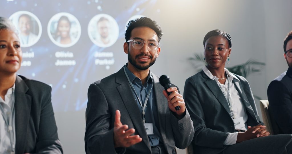 Blockchain startup timestamping in action with man speaking at a conference.