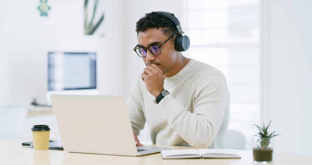 Person focused on laptop work. Education certificate verification with TimeBinder
